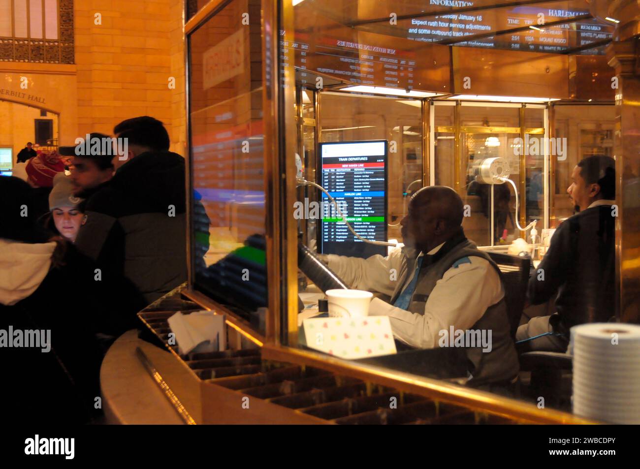 New York, United States. 09th Jan, 2024. A person sits inside an information booth, right, in the main concourse of Grand Central Terminal in midtown Manhattan, New York City. Credit: SOPA Images Limited/Alamy Live News Stock Photo