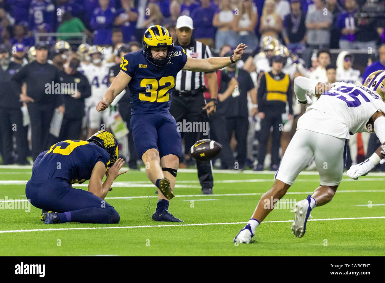 Michigan Wolverines place kicker James Turner (32) kicks an extra point against the Washington