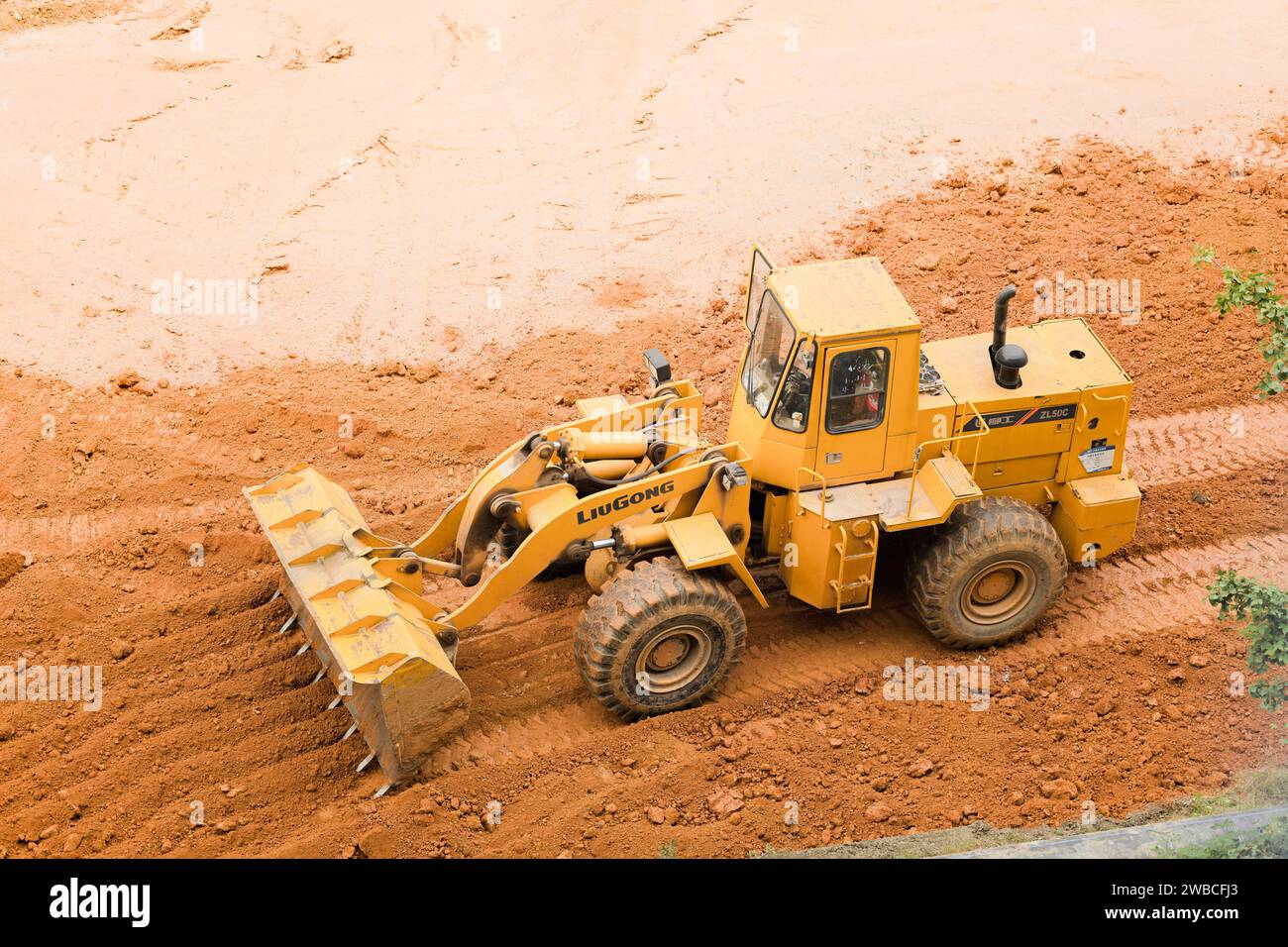 Excavator digging the land Stock Photo - Alamy