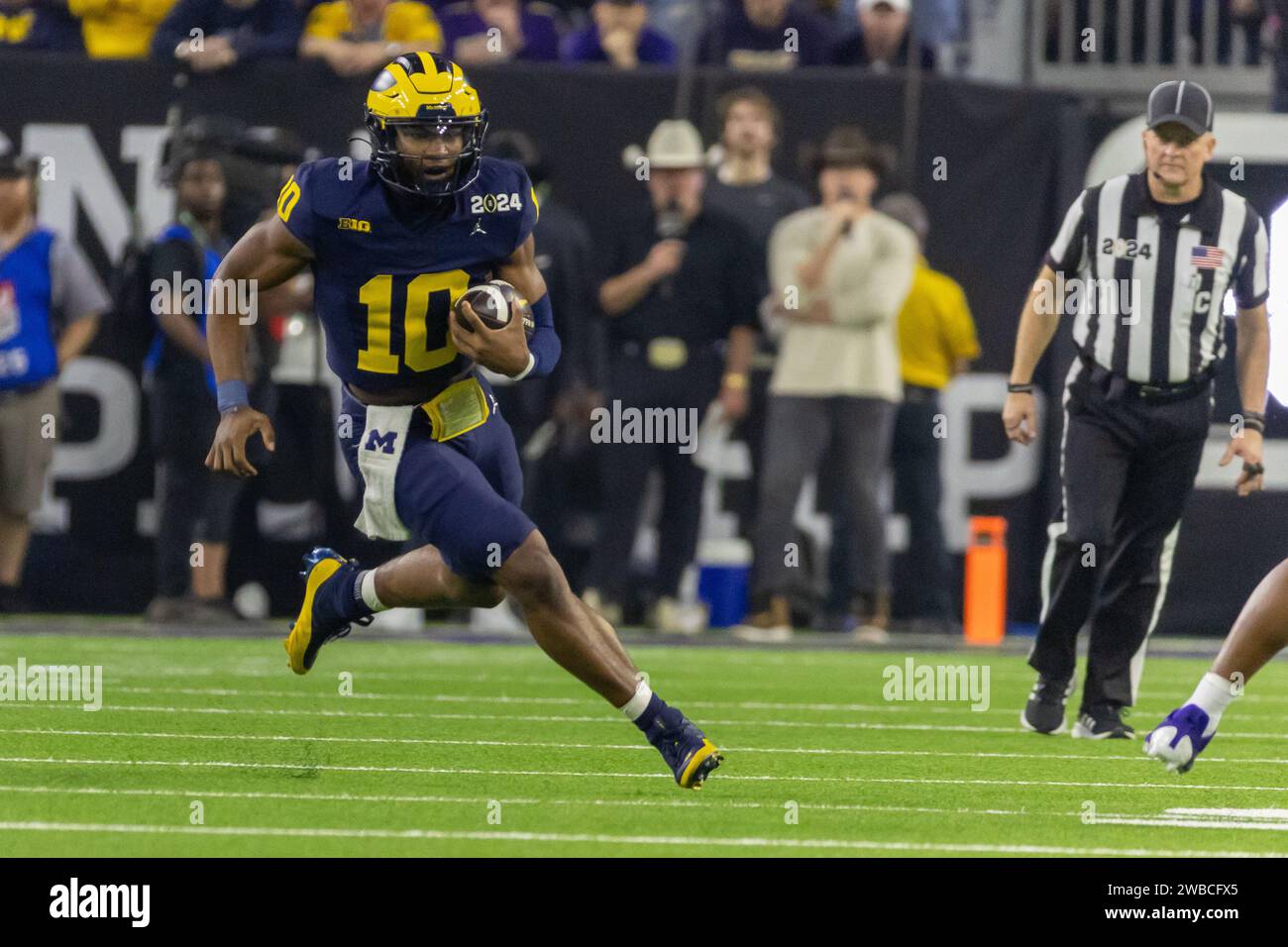 Michigan Wolverines quarterback Alex Orji (10) carries the ball against the Washington Huskies defense during the 2024 College Football Playoff Nation Stock Photo