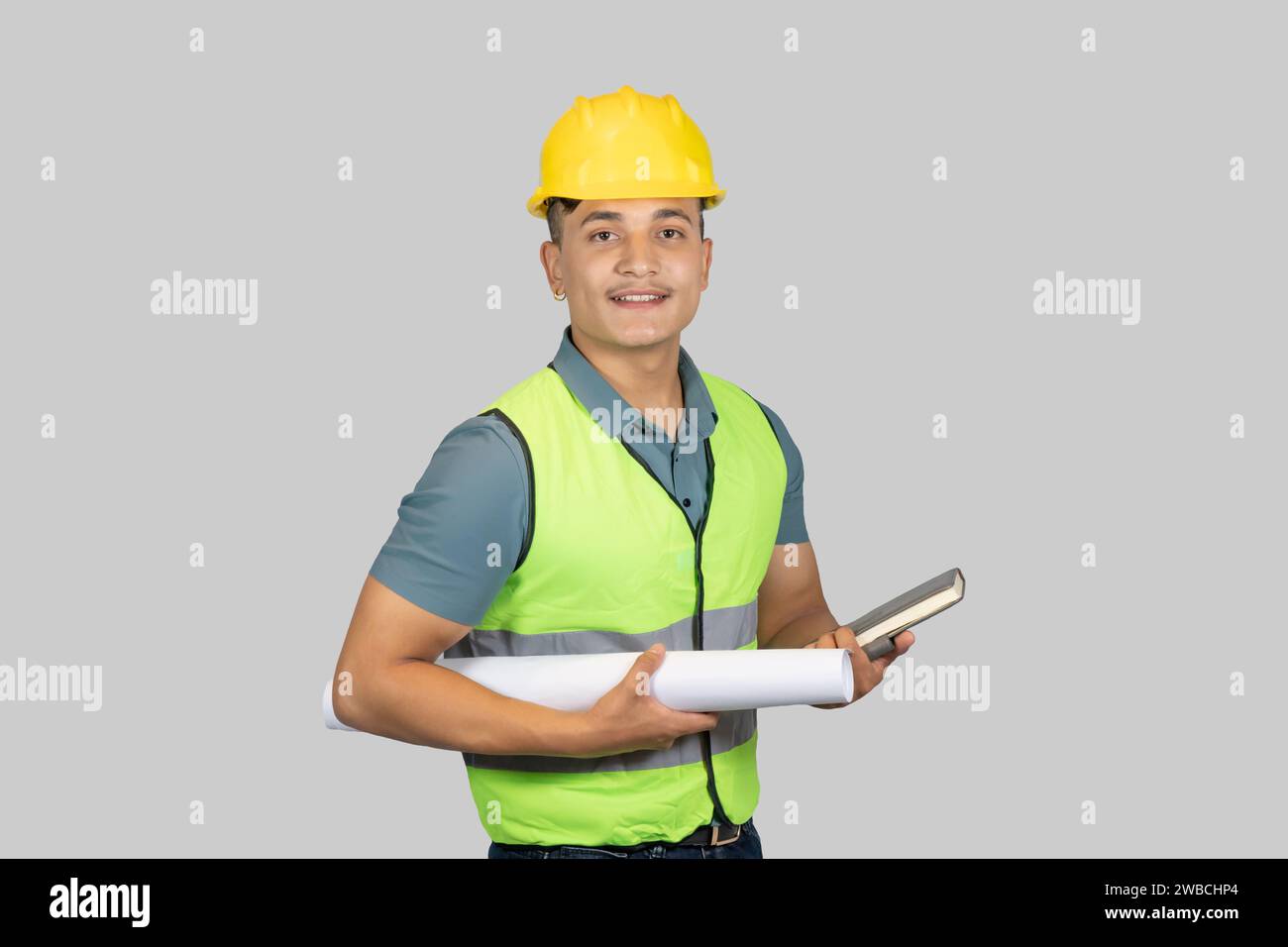 An Asian Happy Construction Worker Engineer giving expression gestures with chartpaper and notebook Stock Photo