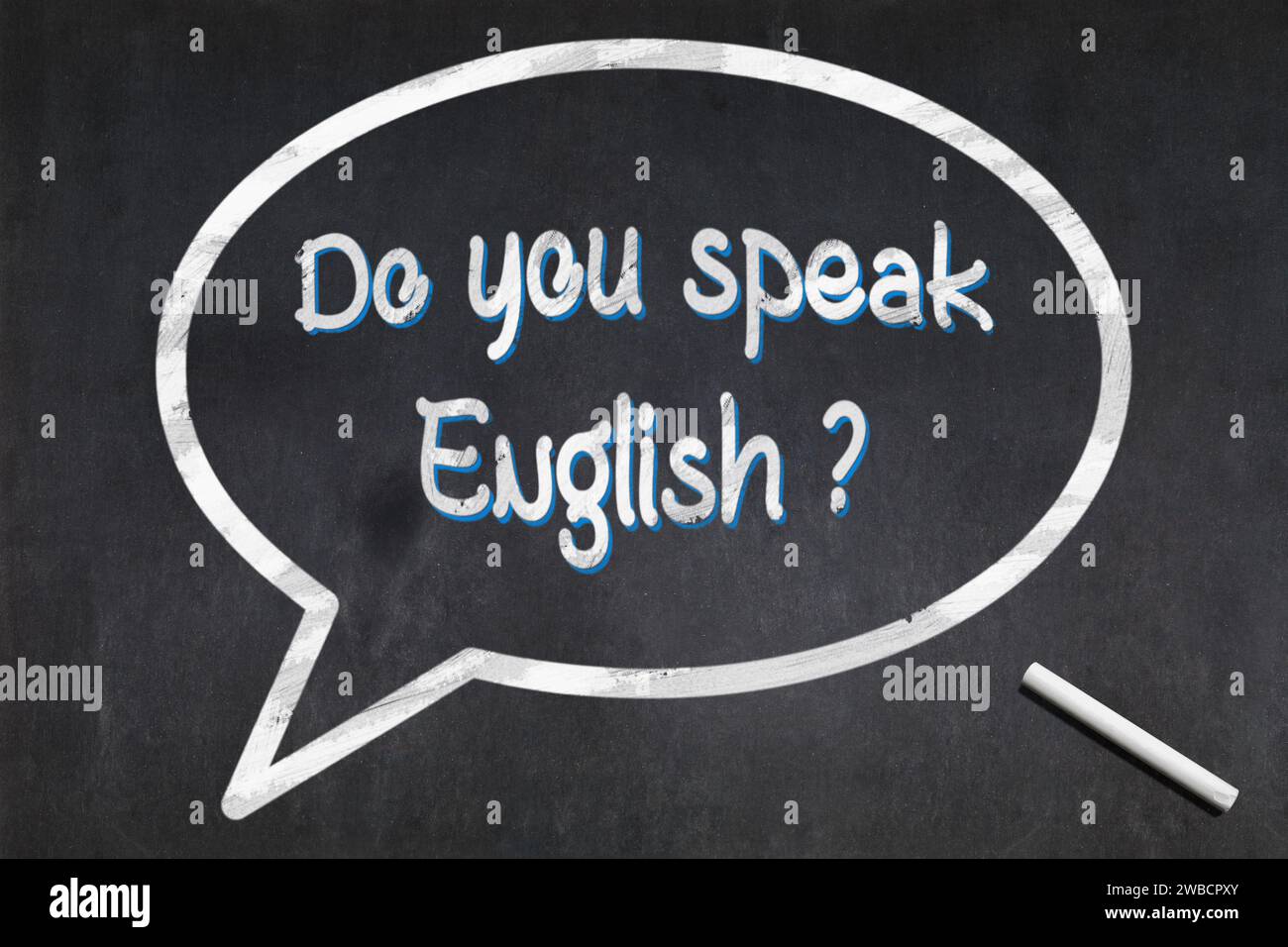 Blackboard with a bubble drawn in the middle with the short phrase 'Do you speak English ?' Stock Photo