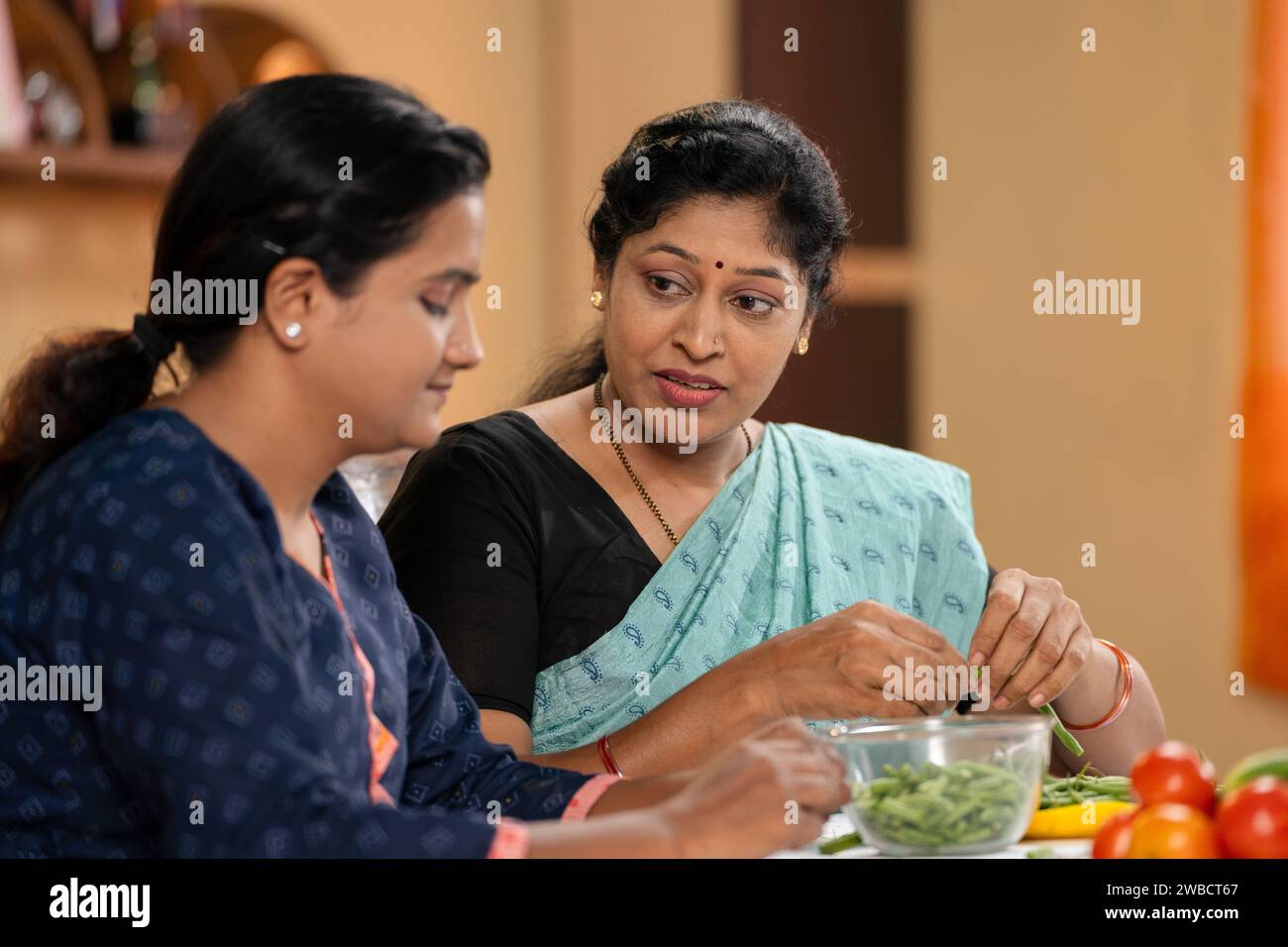 joyful working middle aged Mother with daughter spending time together at home - concept of positive emotion, sharing thoughts and relationship Stock Photo