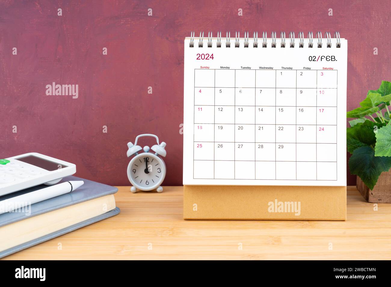 February Monthly desk calendar for 2024 year and calculator on wooden ...