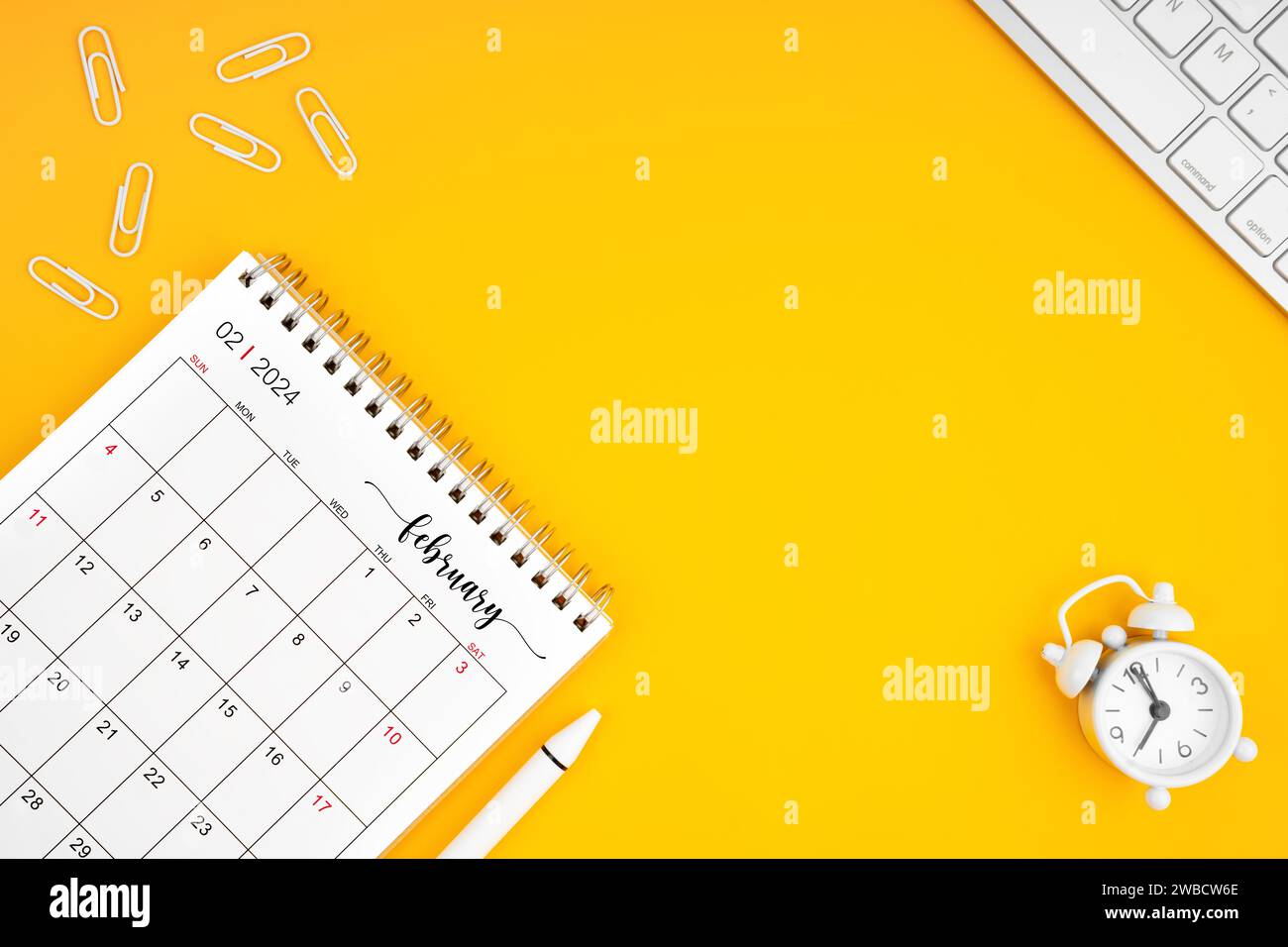 February 2024, Monthly desk calendar for 2024 year and alarm clock with ...