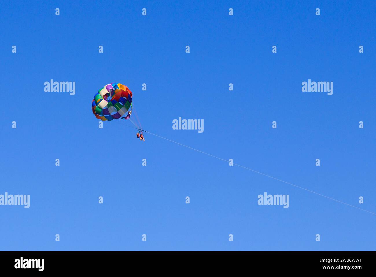 BARSELONA, SPAIN - MAY 13, 2017: These are unidentified people in a parachute flight while doing parasailing. Stock Photo
