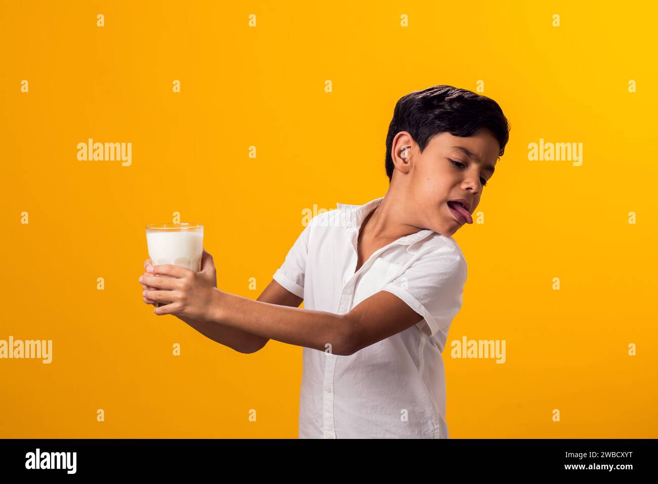 Boy with glass of milk feeling stomach pain. Dairy Intolerant person