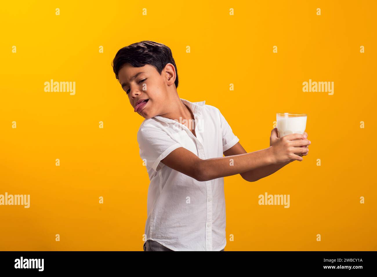 Boy with glass of milk feeling stomach pain. Dairy Intolerant person