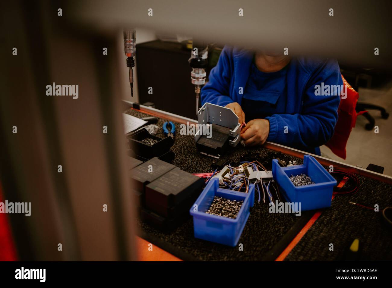 Close-up of hands of young computer engineer fixing broken pc parts at the desk in the home office. Stock Photo