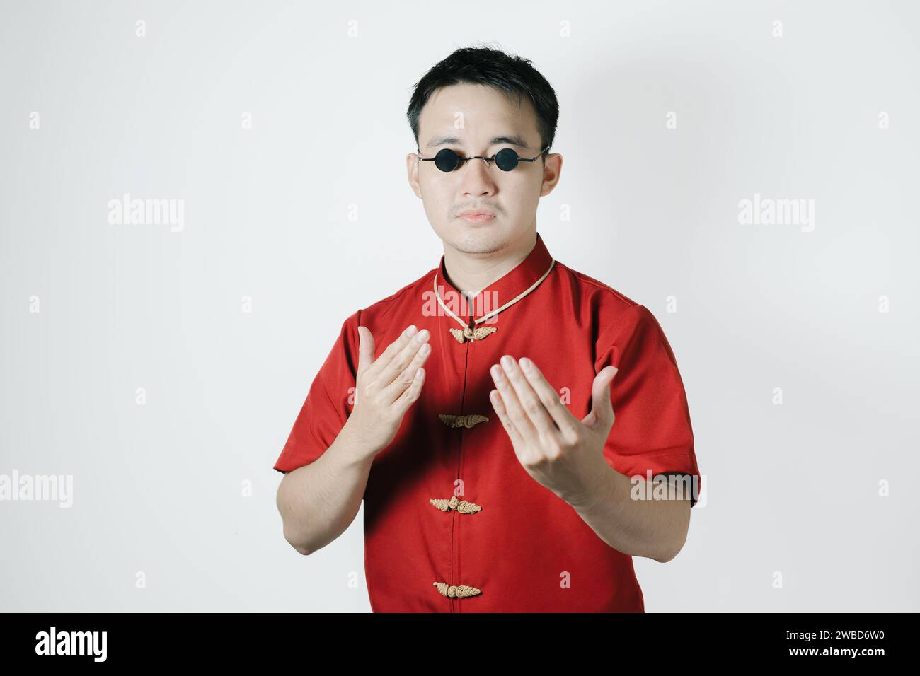 Asian man wearing traditional costume with gesture of wing chun kung fu