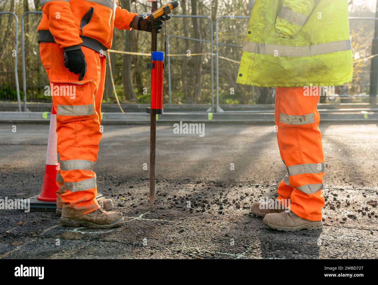 Site engineer surveyor and site manager discussing plan of works on construction site during new road construction Stock Photo