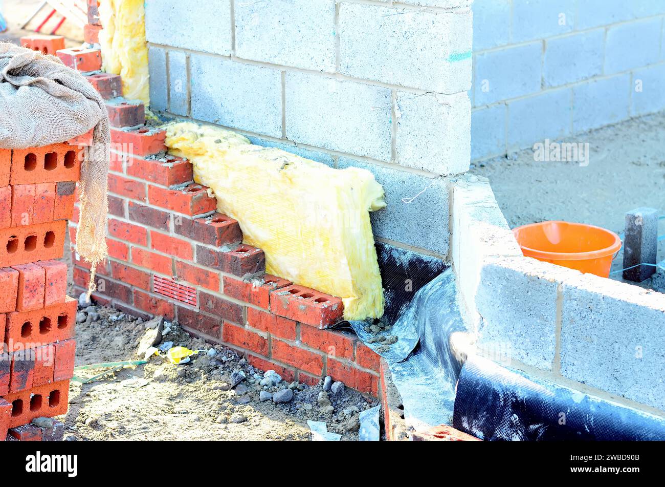 Insulating walls of new build houses by placing rock wool inside wall