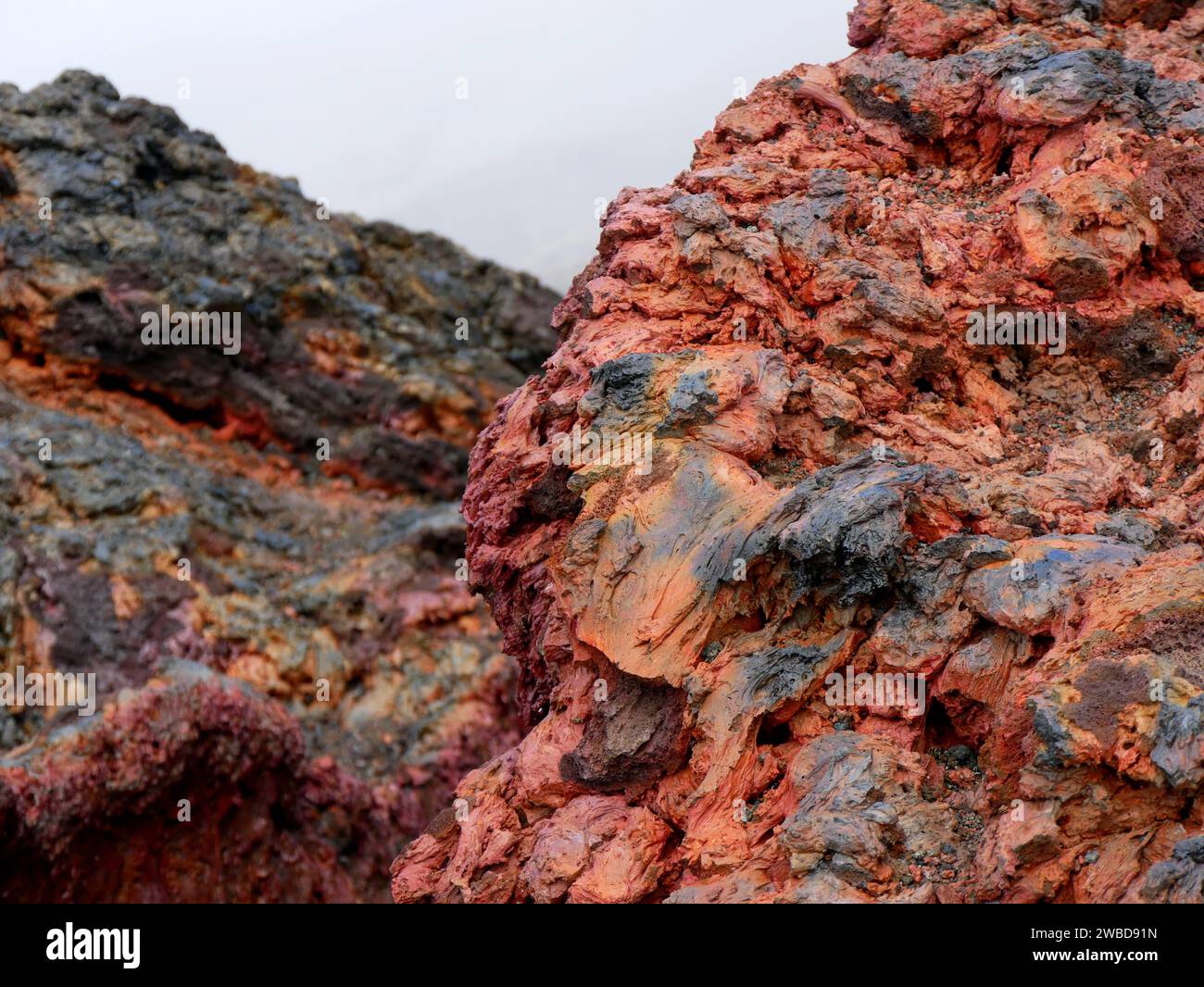 Red colored volcanic rock on the summit of Dolomieu crater, Piton de la Fournaise, Reunion Stock Photo