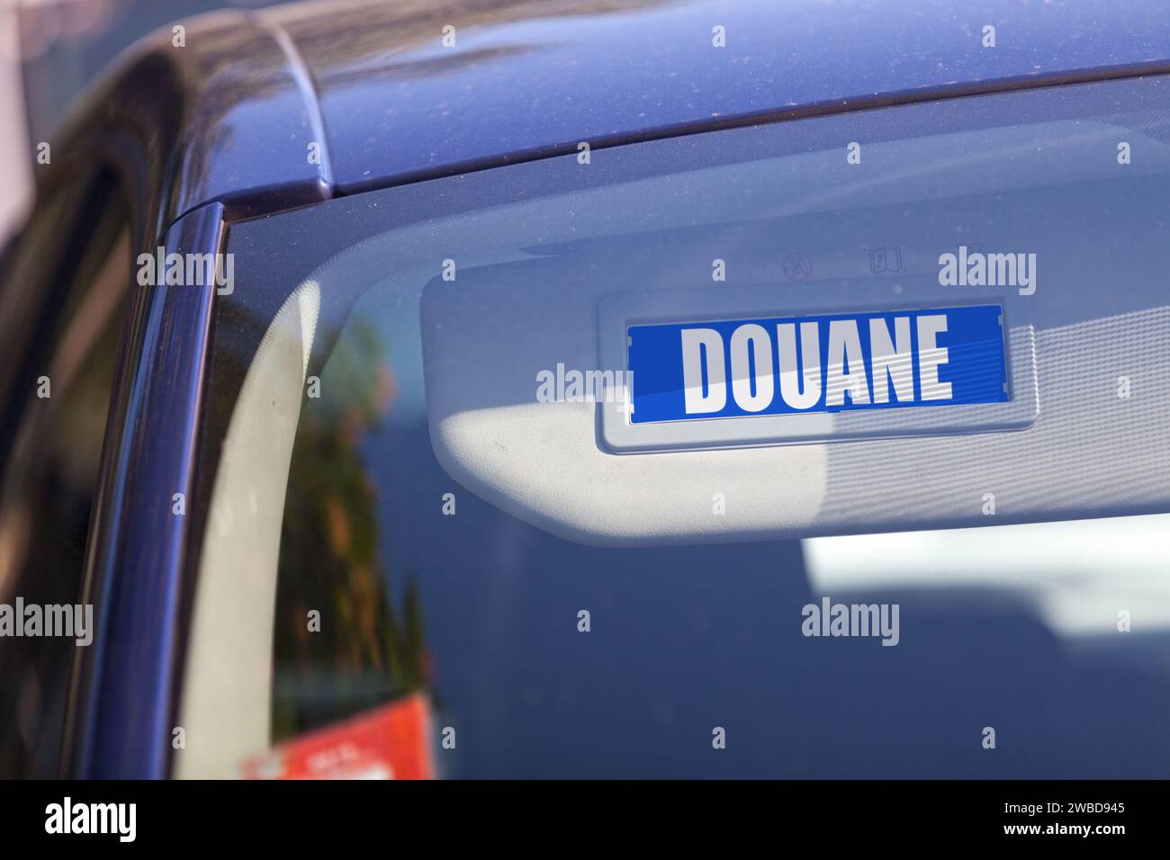 Blue sun visor with written in French 'Douane' meaning in English 'Customs'. Stock Photo
