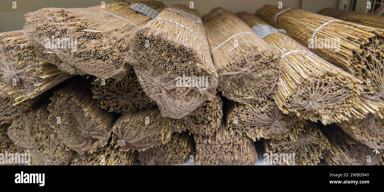 Garden fence rolls built with thin bamboo canes. Selective focus Stock Photo