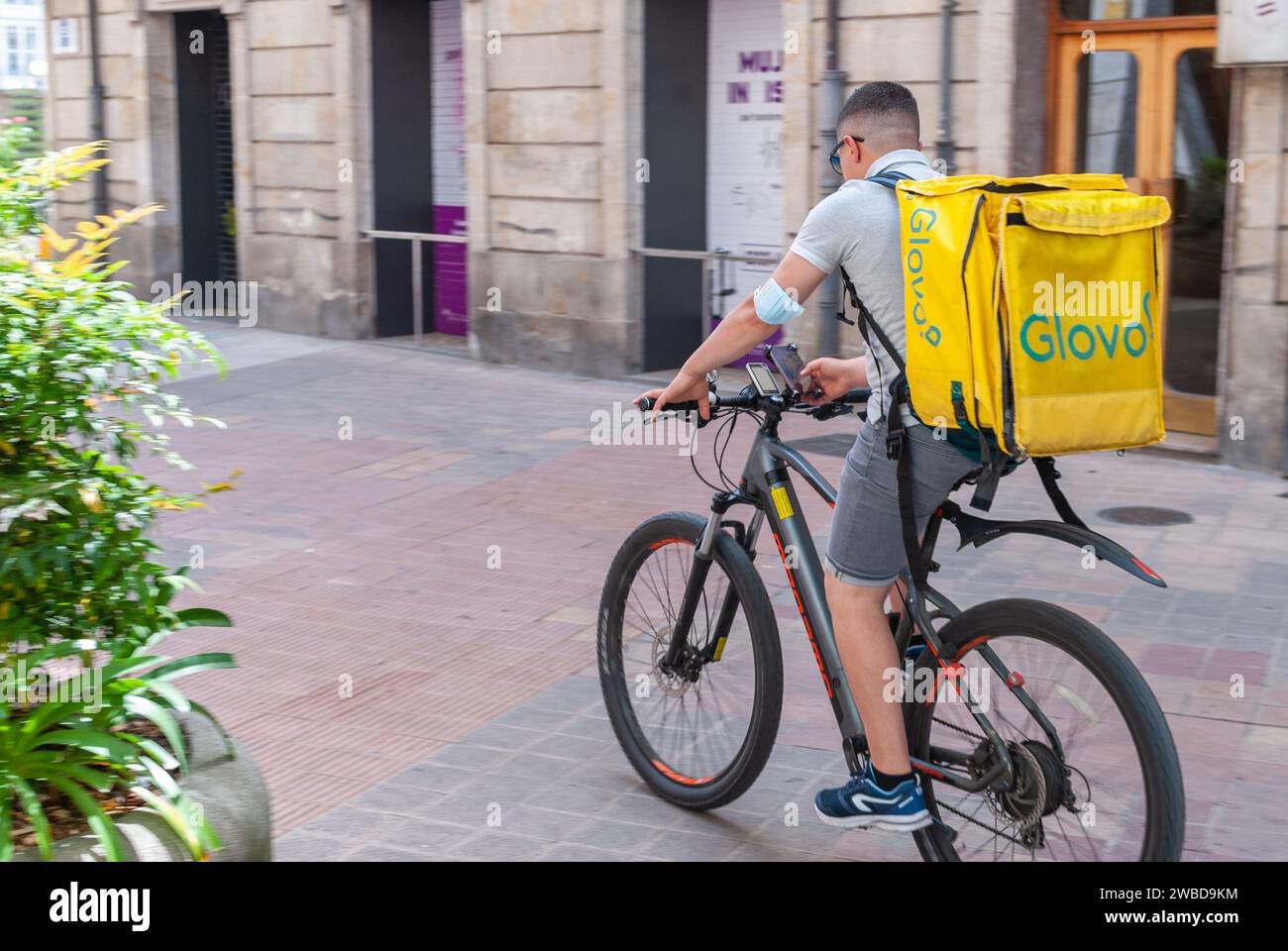 Vitoria, Euskadi, Basque Country - January 28, 2020 - Photo of fast food delivery boy, concept of change of traditional gastronomic culture. Stock Photo