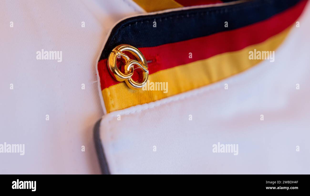 Duesseldorf, Germany. 10th Jan, 2024. A golden pretzel and the national