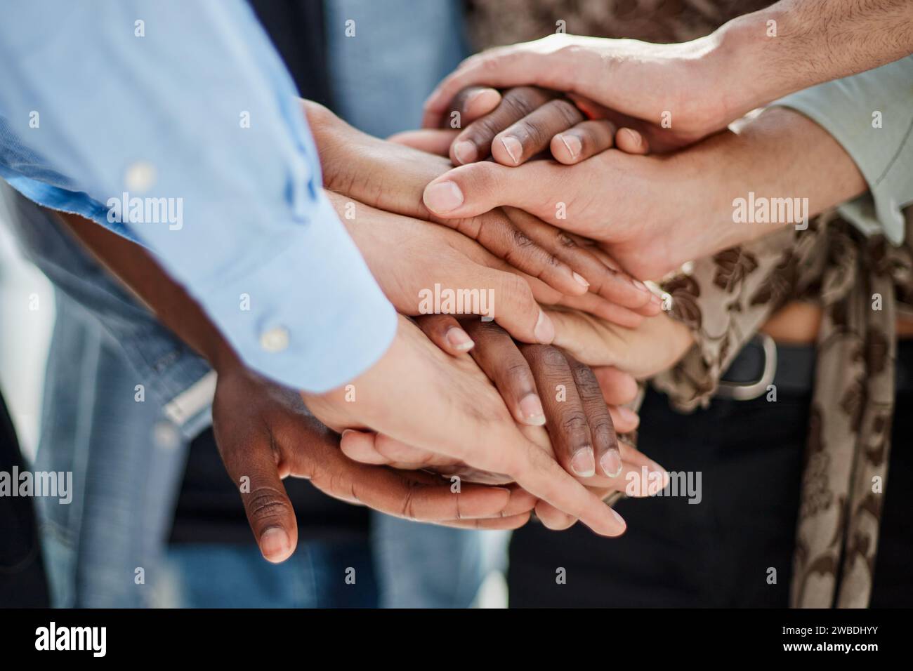 a group of successful business diverse people in the office stands embracing Stock Photo
