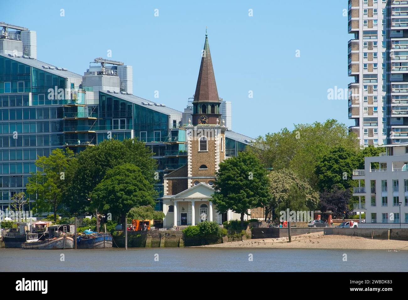 Battersea's beauty: The grandeur of St Mary's Church reflected in the waters of the Thames, with a touch of drama in the sky. Stock Photo