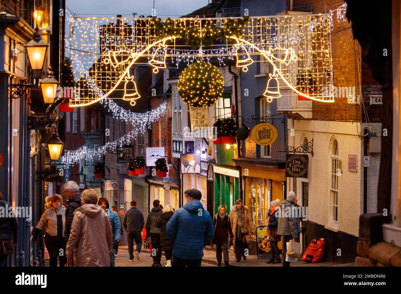 The top of Steep Hill, Lincoln in an area known as Bailgate. In 2024 new Christmas lights have been installed to brighten the journey up the steep hill with shops on either side. The area is also known for it's historical connections, quaint English shops and pubs and restaurants. Stock Photo