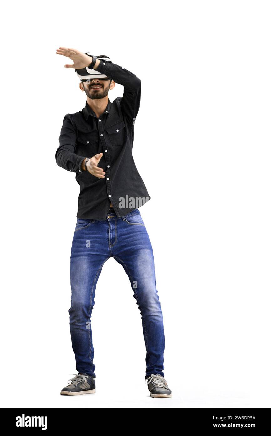 Man, on a white background, full-length, wearing VR glasses Stock Photo
