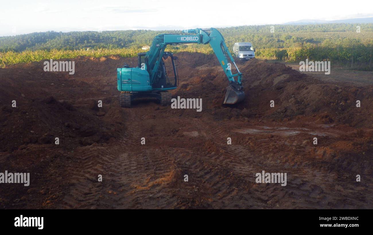 kobelco excavator at a construction site, heavy machinery for earthworks and building project kobelco Excavator at a construction site Stock Photo