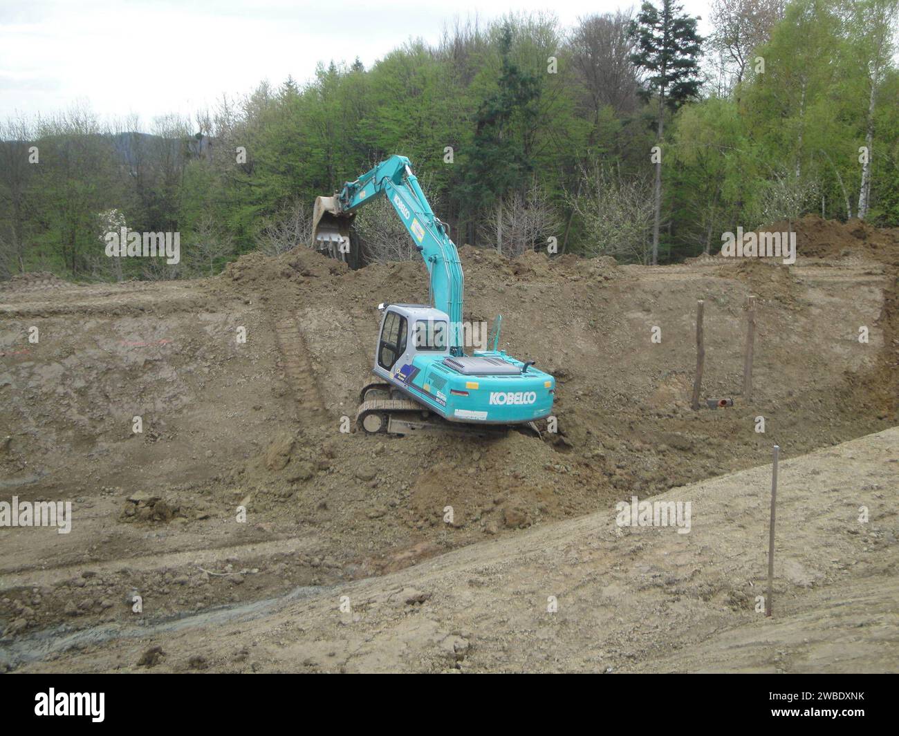 kobelco excavator at a construction site, heavy machinery for earthworks and building project kobelco Excavator at a construction site Stock Photo