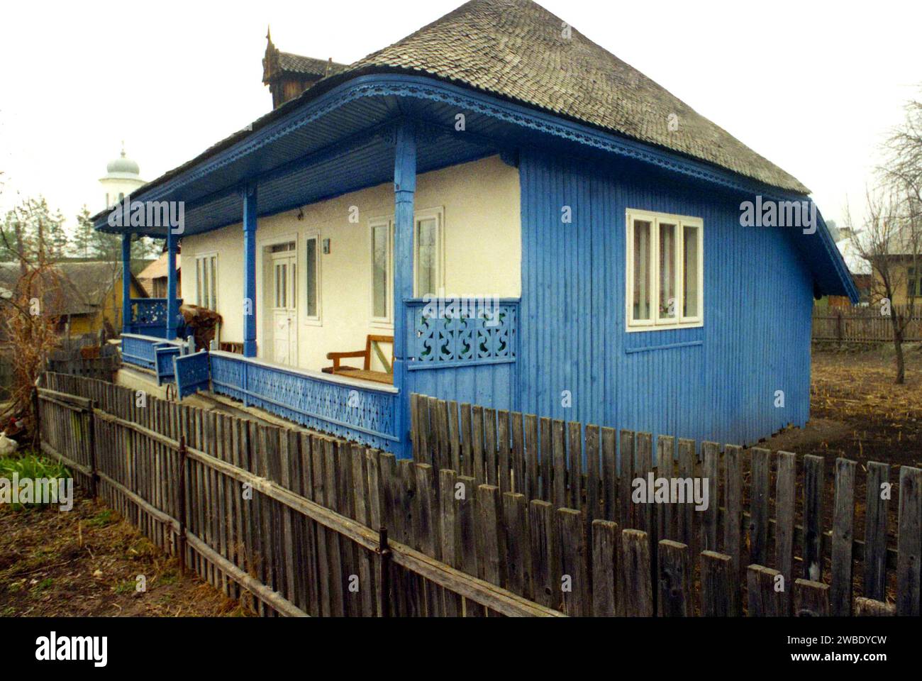 Negrilești, Vrancea County, Romania, approx.. 1998. Exterior of a traditional wooden house with fretwork on the porch and under the roof. Stock Photo