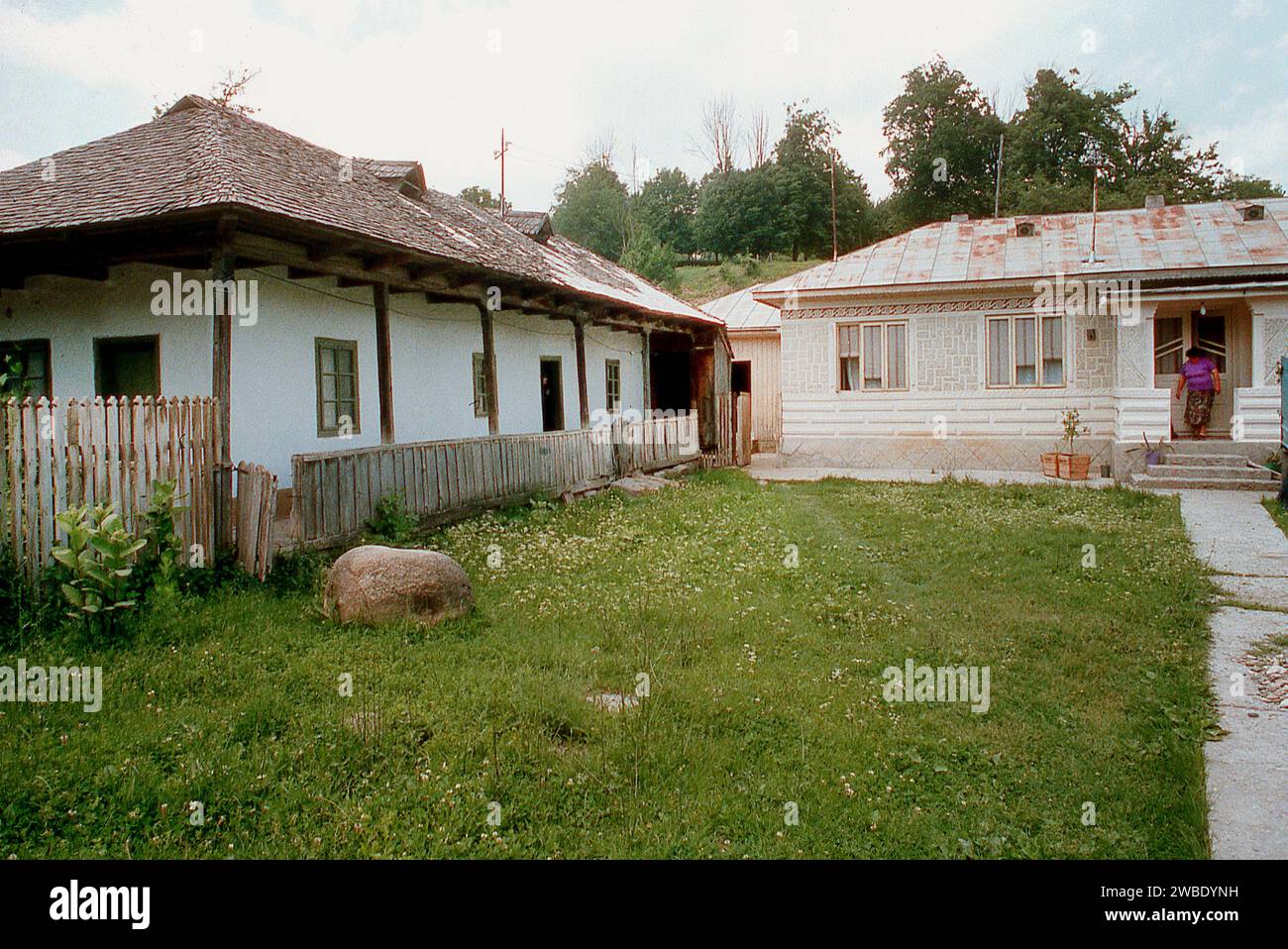 Vrancea County, Romania, approx. 1991. A homestead with an old simple traditional house on the left (probably late 19th century) and a newer one (probably middle of the 20th century) seen in front. Stock Photo