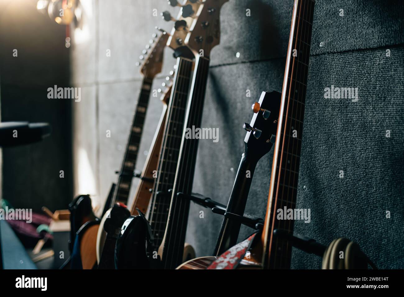 Music instruments in room. Guitars stay in row. Sound recording studio background. Stock Photo