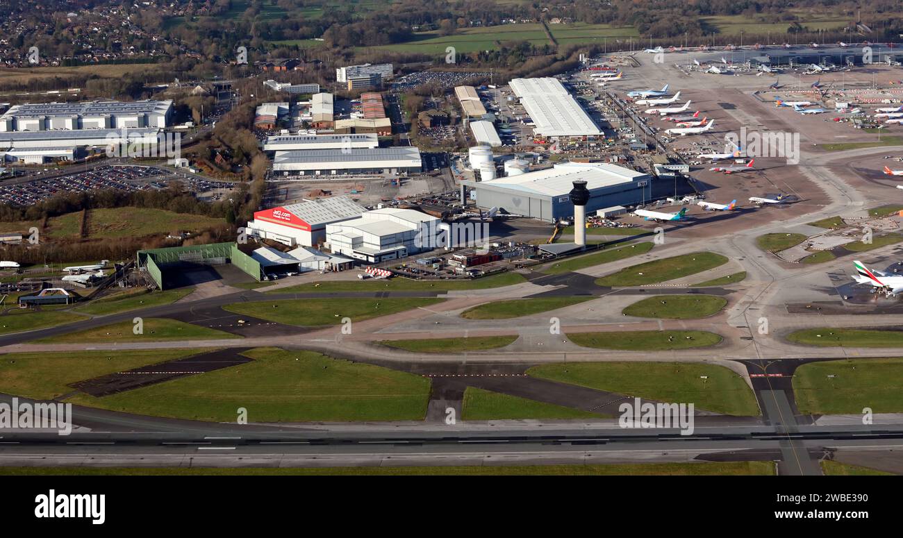 Aerial view of the North side of Manchester Airport's runway. Including Cargo handling, Fire Station, Signature Aviation, Swissport & STS Aviation. Stock Photo