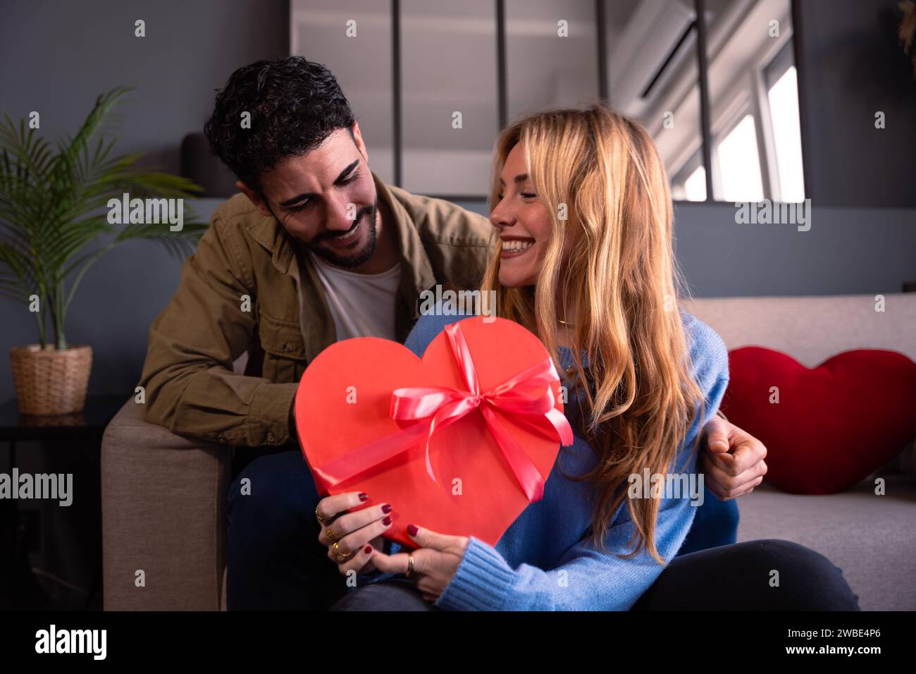 Loving young couple with heart-shaped gift box. Valentine's Day ...