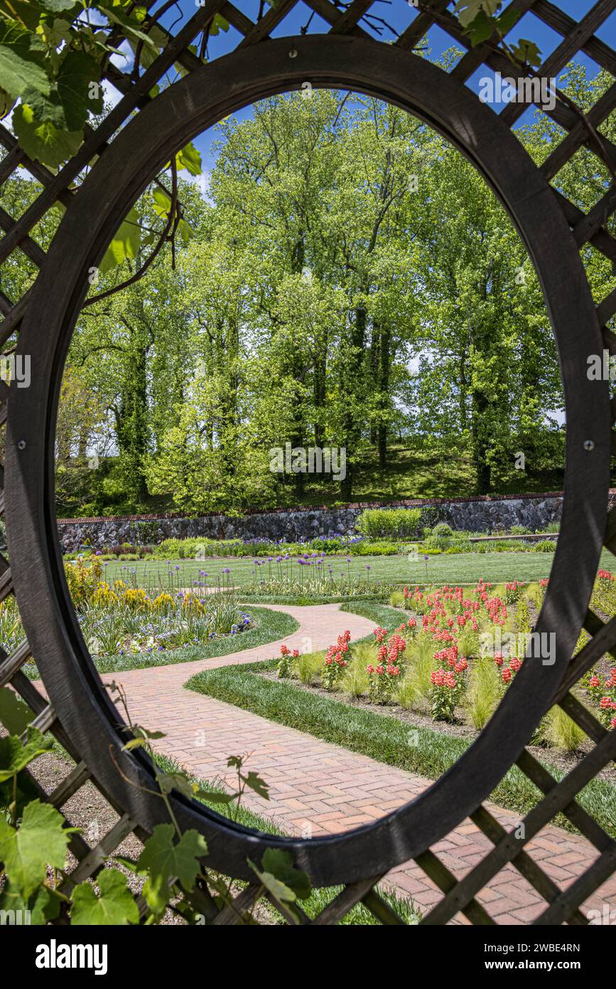 Looking at a country garden through a fence Stock Photo