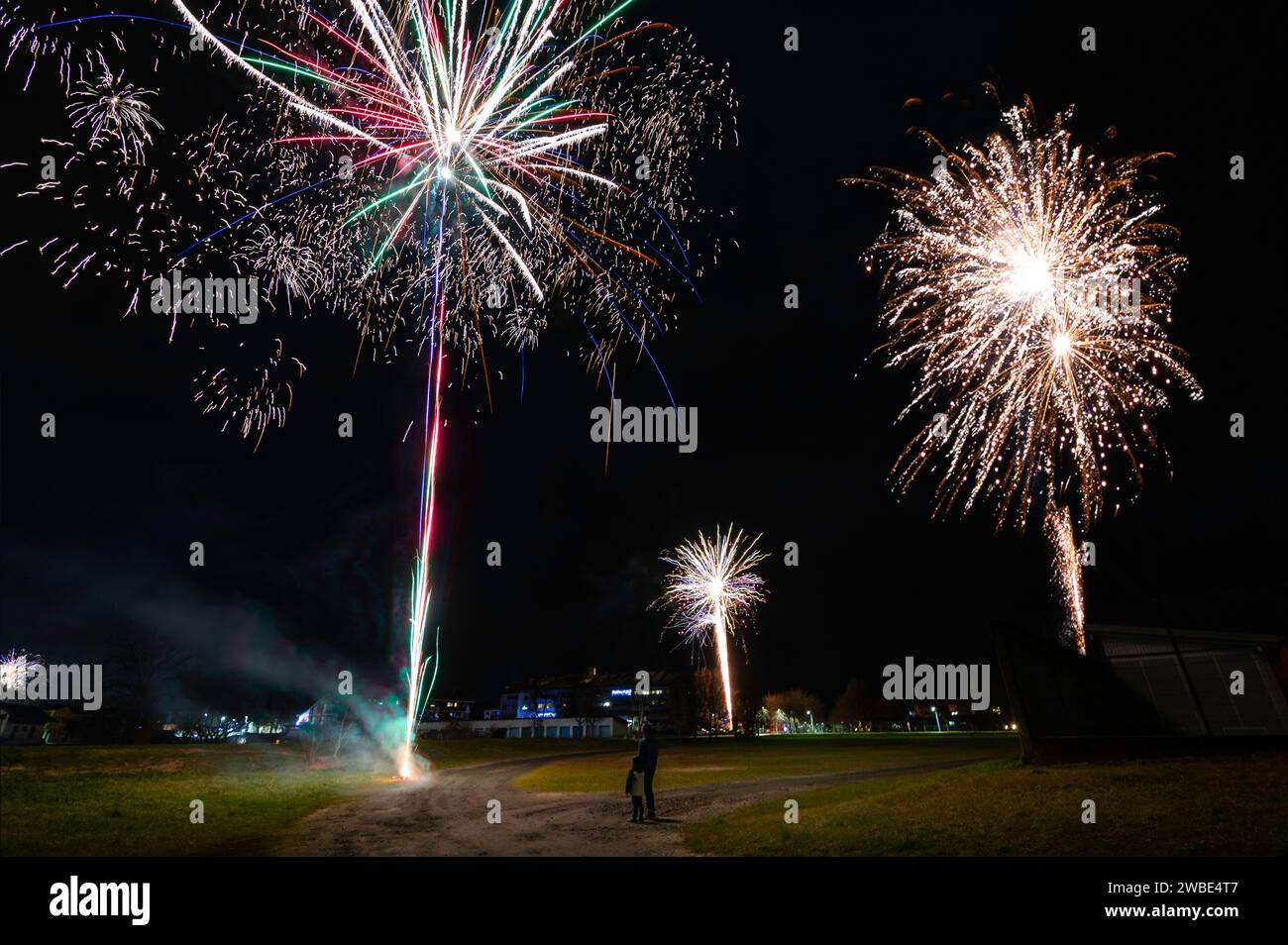 Me and my son standing still and careful watching fireworks from the distance and celebrating the new year 2024. The explosions were realy spectacular Stock Photo
