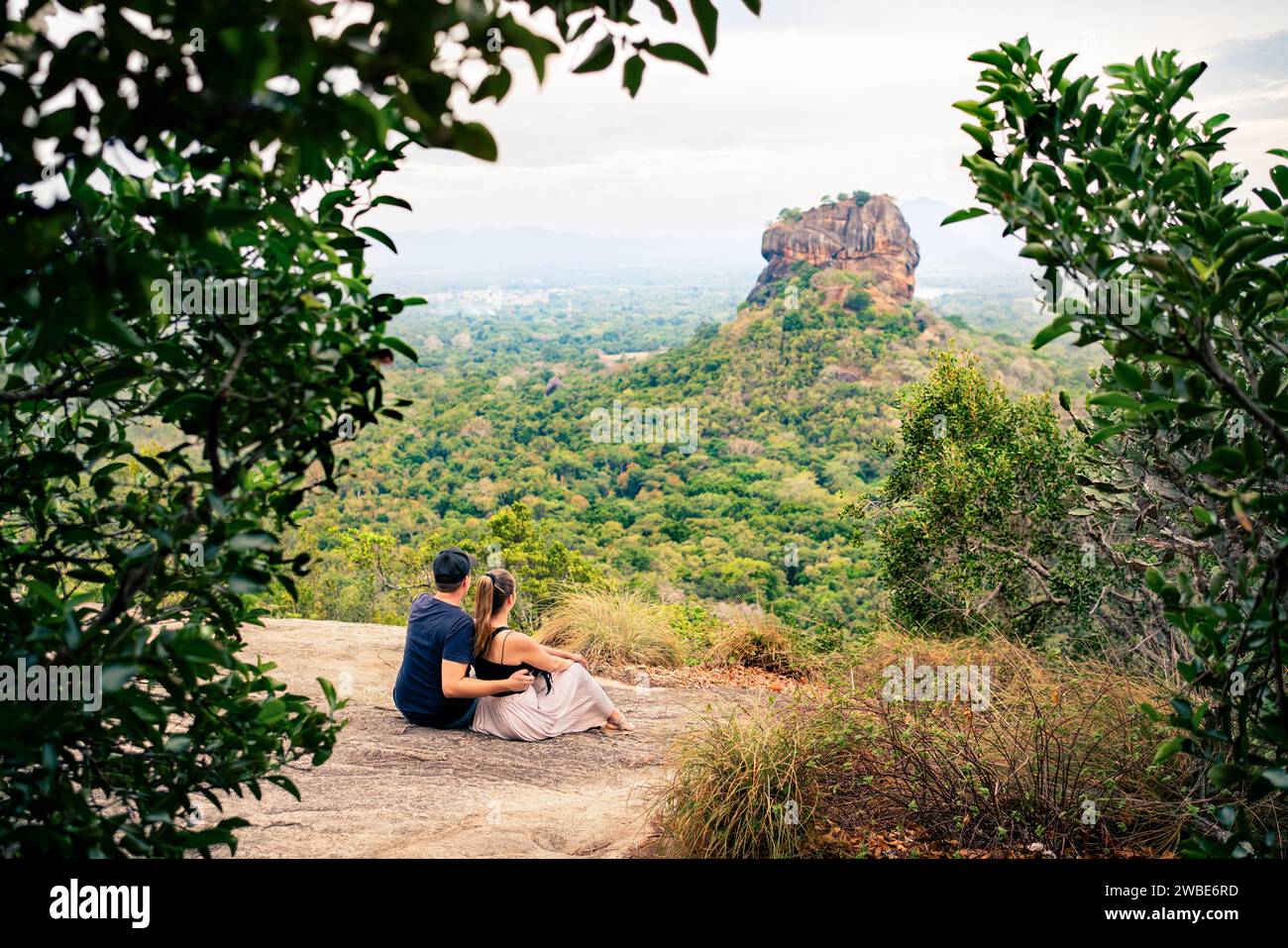 Couple in Sigiriya on honeymoon or family vacation. Woman and man on mountain in summer. Happy people and beautiful green landscape view. Stock Photo