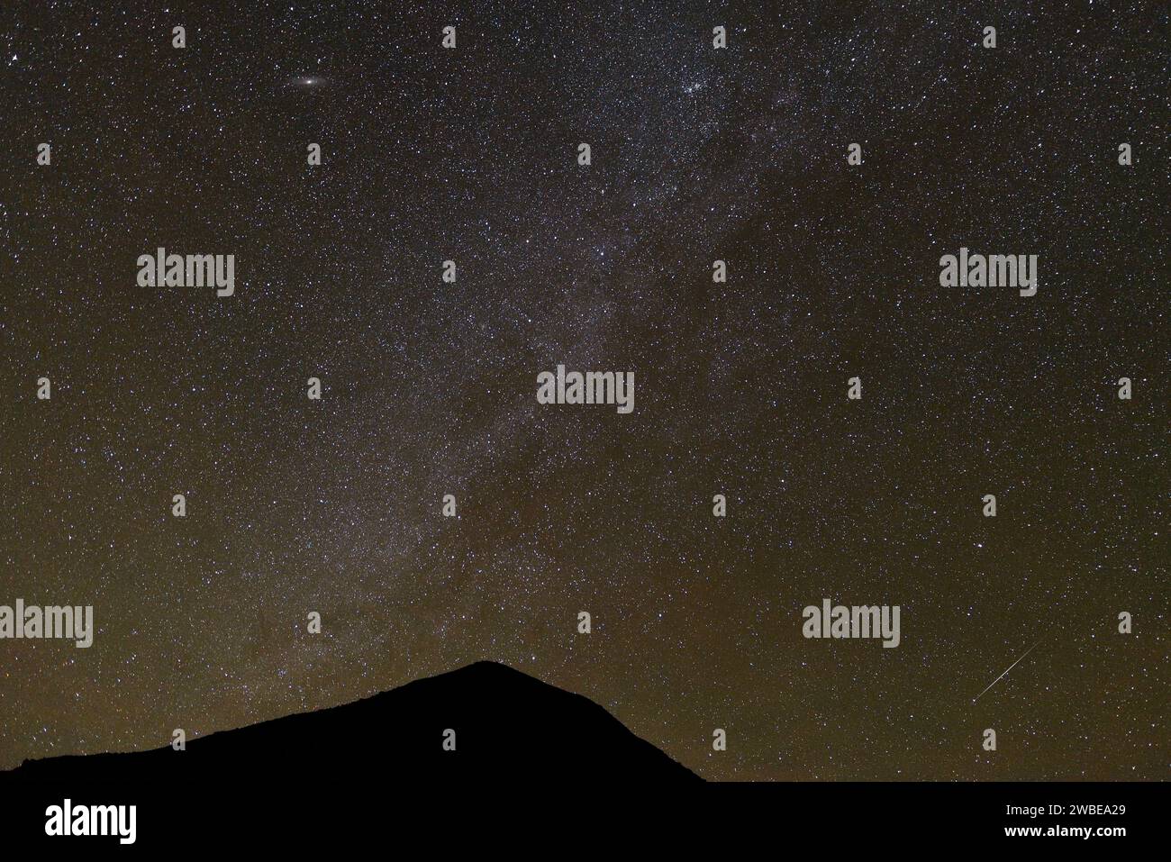 MILKY WAY AND THE SHOOTING STARS DURING THE GEMINID METEOR SHOWER IN THE ALGERIAN DESERT Stock Photo