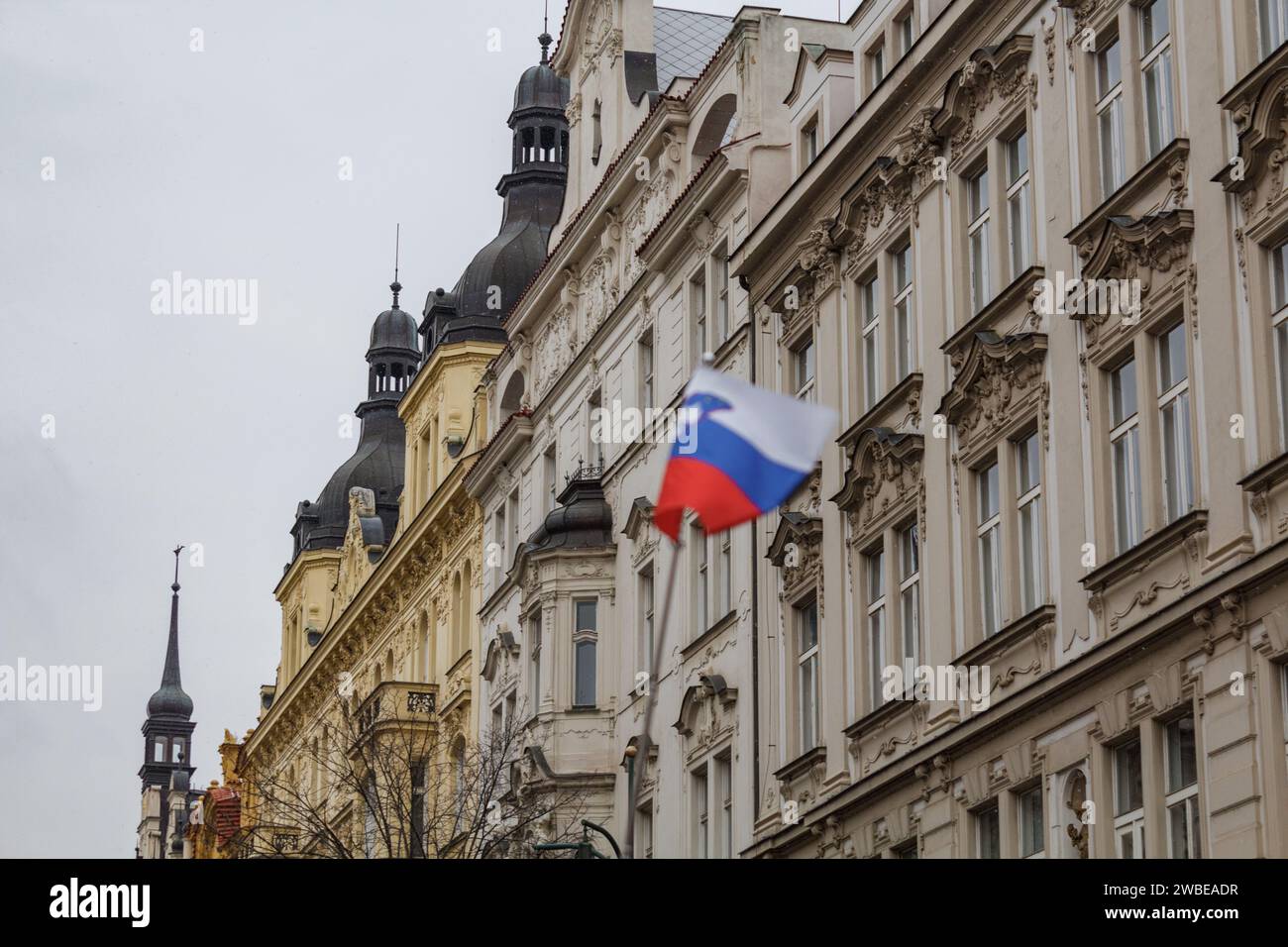 A slovenian flag in front of a historic building in Prague city on a freezing cold december day Stock Photo