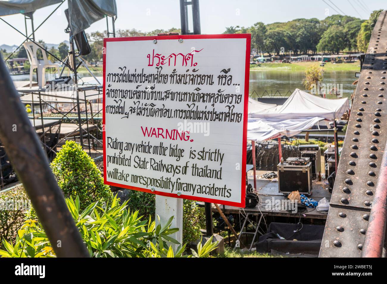 A warning sign on the bridge over the River Kwai, Kanchanaburi, Thailand. Stock Photo