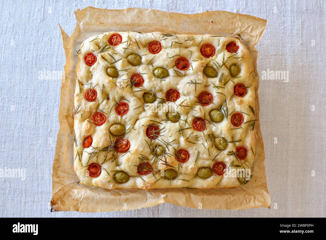 Homemade Italian flatbread Focaccia with cherry tomatoes, olives and