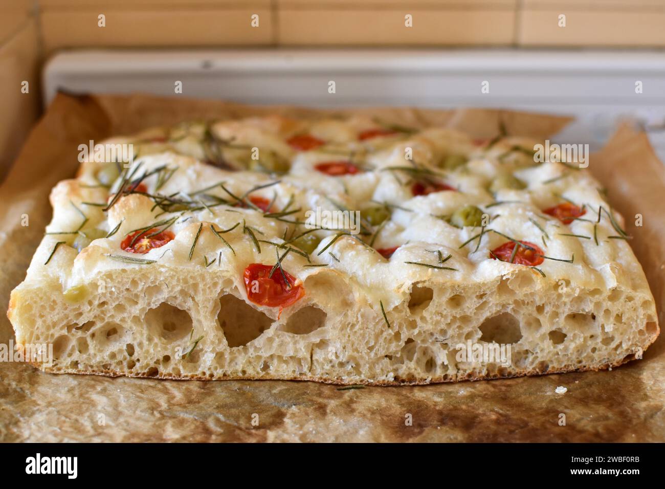 Homemade Italian flatbread focaccia with cherry tomatoes, olives and