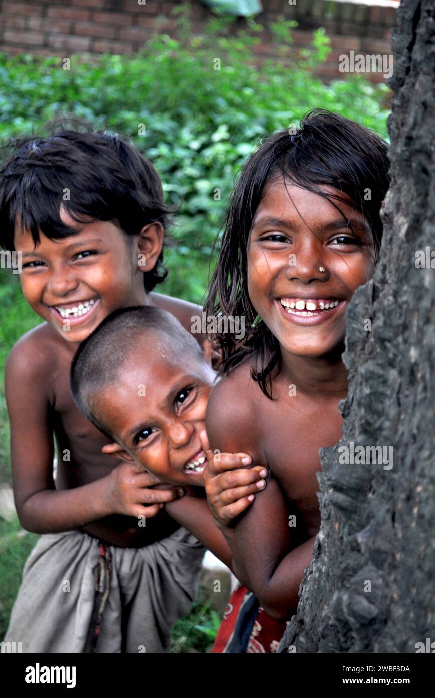 Portrait of two children playing hide and seek in the slums of Rayer