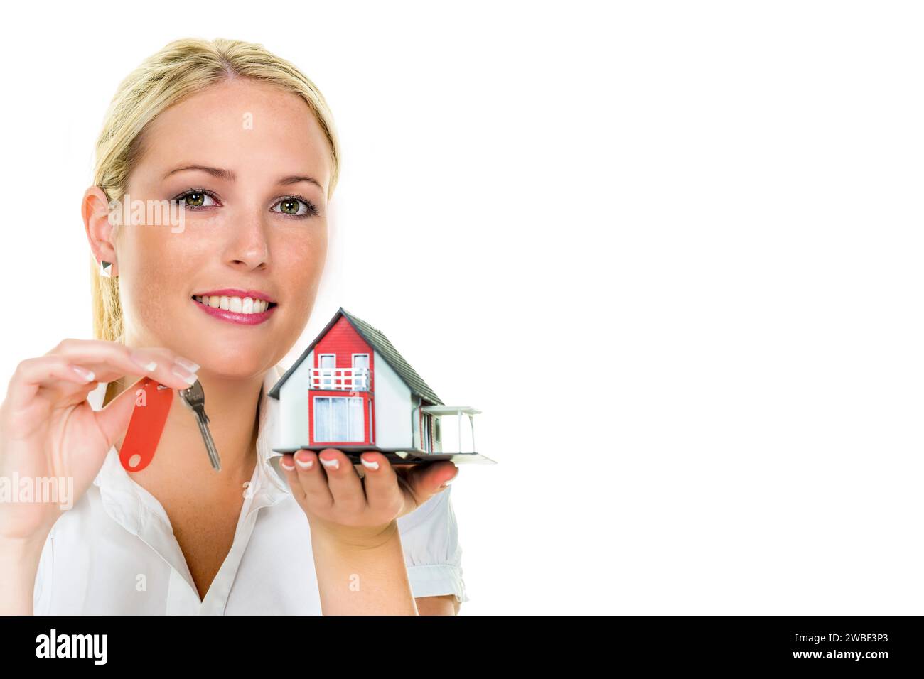 A woman protects your house and home. Good insurance and serious financing reassure, blonde, 30, years, model house, house key Stock Photo