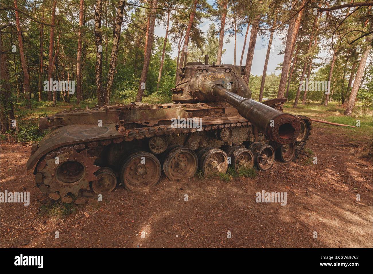 Old tank in the forest with sunbeams shining through the trees, M47 Patton, Lost Place, Brander Wald, Aachen, North Rhine-Westphalia, Germany Stock Photo