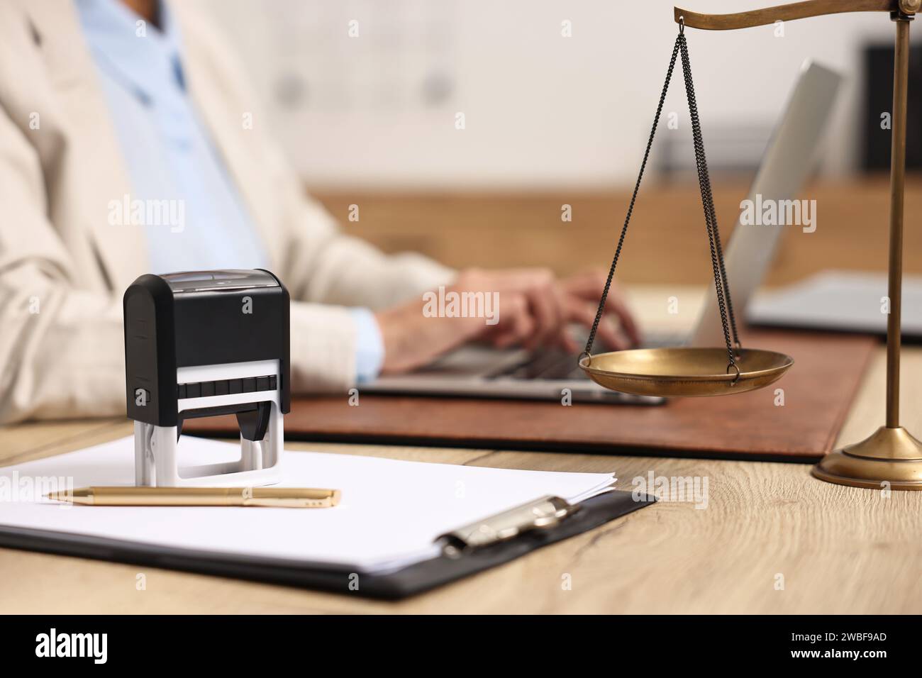 Notary using laptop at workplace in office, focus on stationery and ...