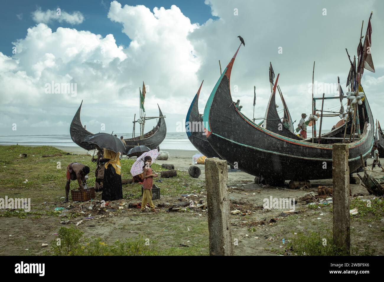 Fishing boats on the beach during a monsoon shower, Cox's Bazar, Bangladesh Stock Photo