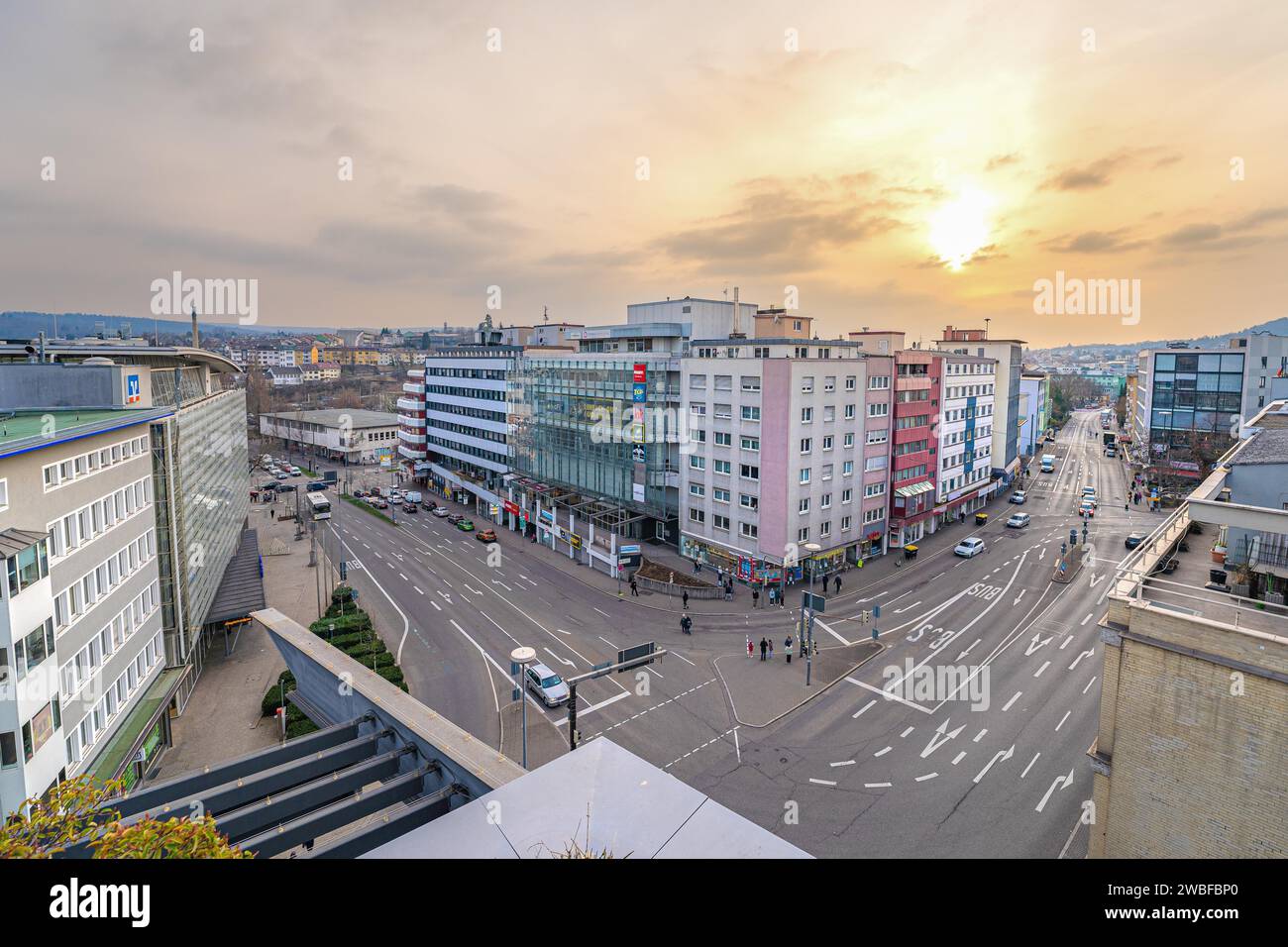Wide view over a city street at dusk with a view of buildings and sky ...