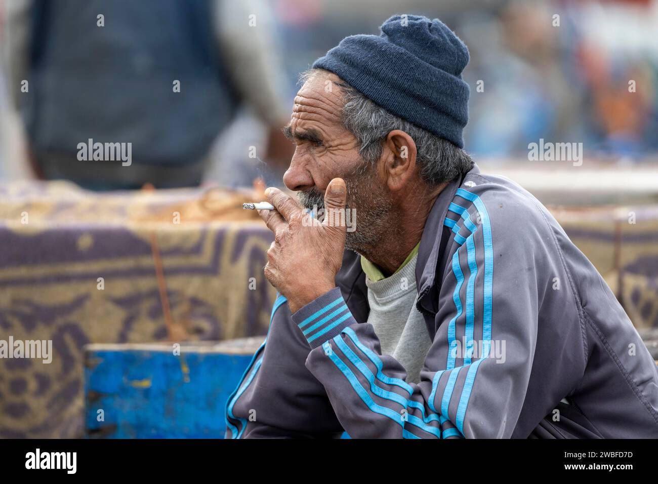 Portrait, Man smoking a cigarette, Harbour, Essaouira, Morocco Stock Photo