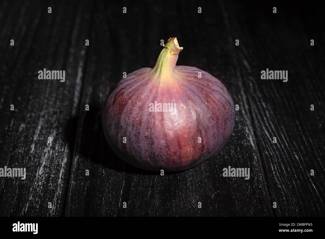 figs on black wood background Stock Photo