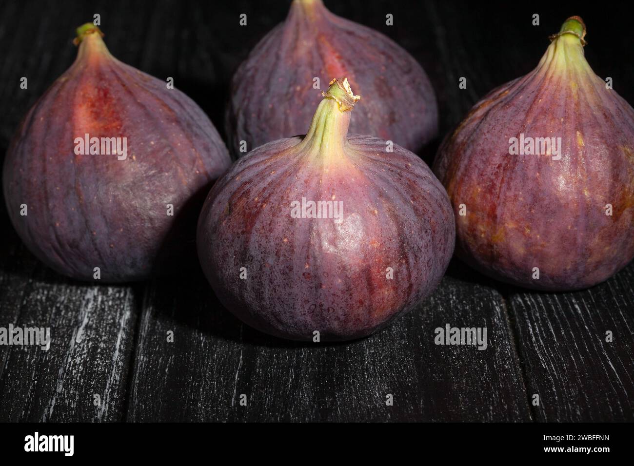 figs on black wood background Stock Photo