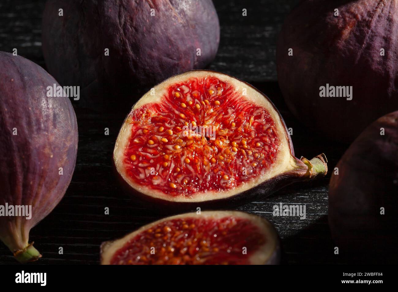 sliced figs on wood background Stock Photo